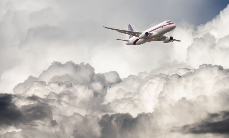 Passenger airplane flying in stormy clouds and air turbulence.