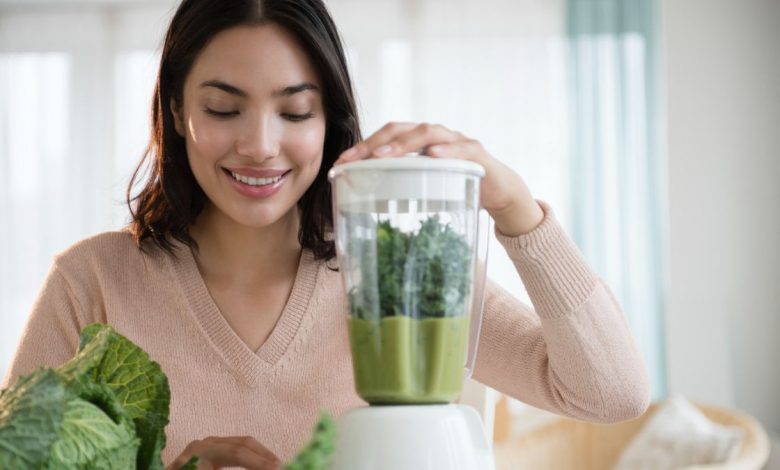 Woman making green smoothie